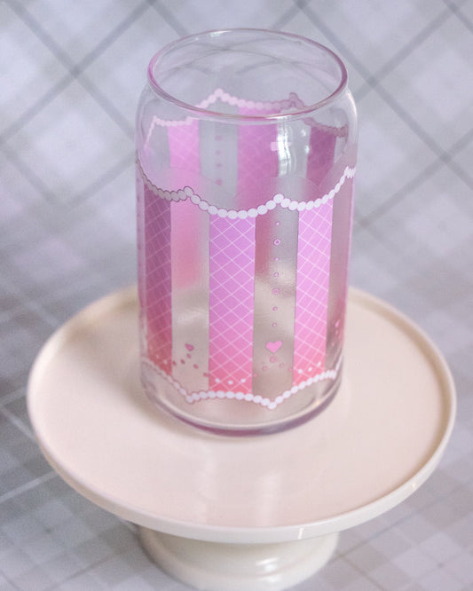 Glass cup with a design of cross hatch pattern on pink background and hearts