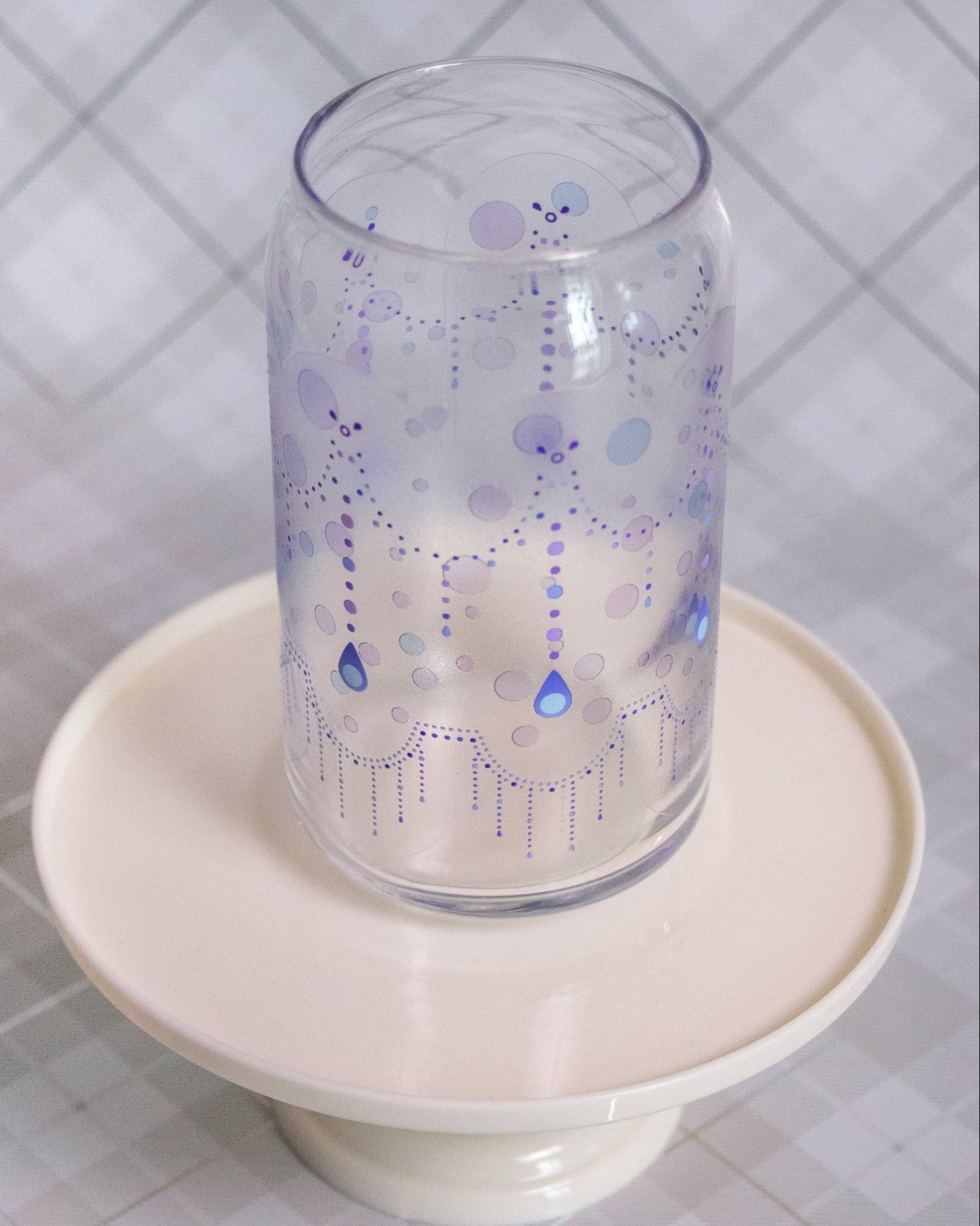 Glass cup with a design pattern of dots