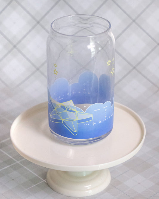Glass cup with a design of star in front of blue low background