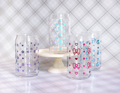 Four glass cups wrapped with vinyl of assorted designs